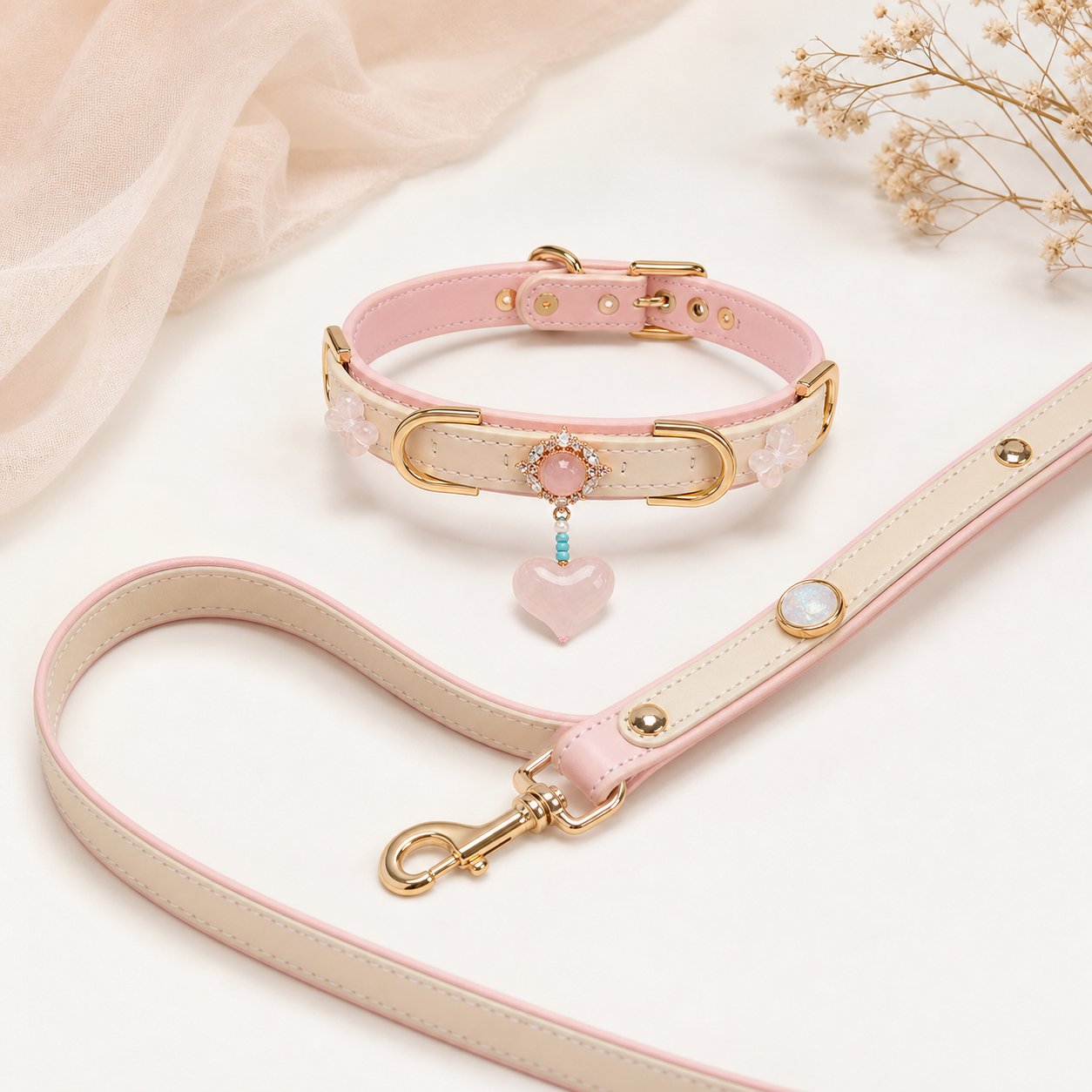 Blush pink XESODIT heart collar and matching leash arranged in a loose curve