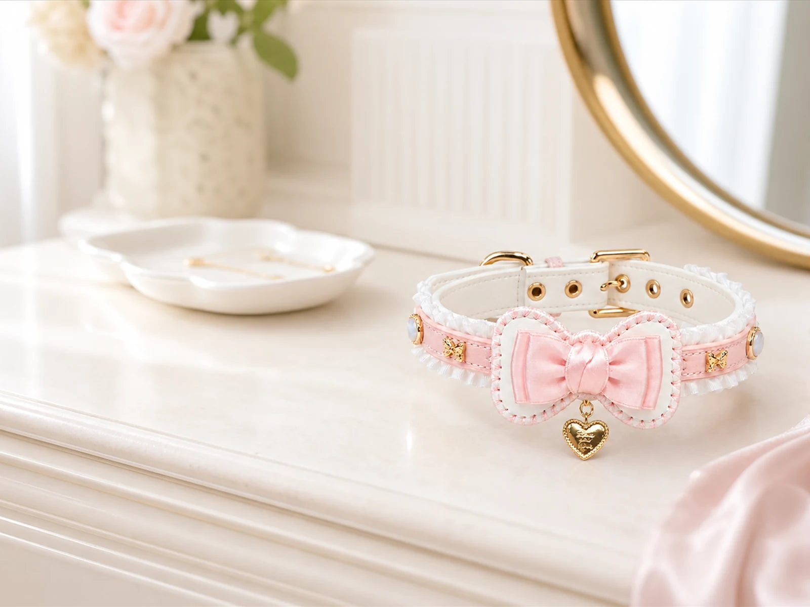 Pink bow XESODIT collar photographed on a white dressing table