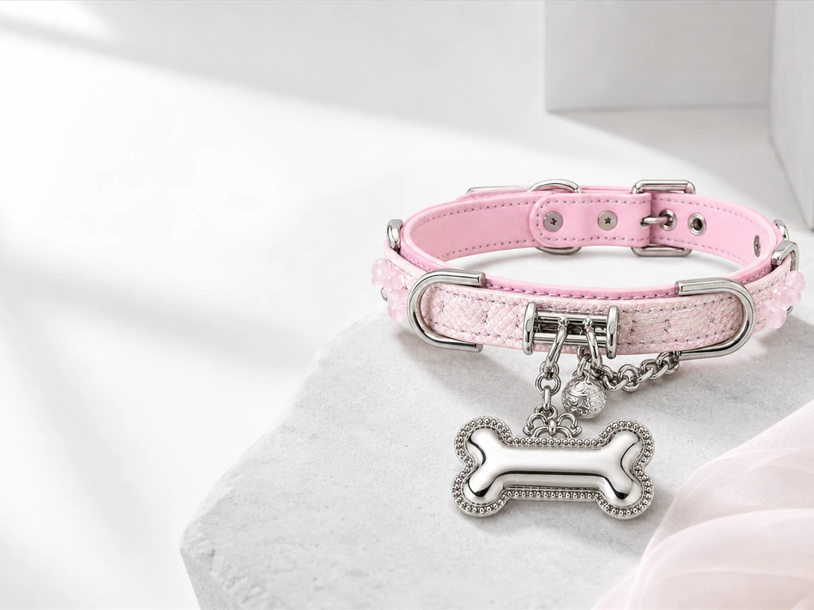 Pink XESODIT collar with polished silver bone charm on stone